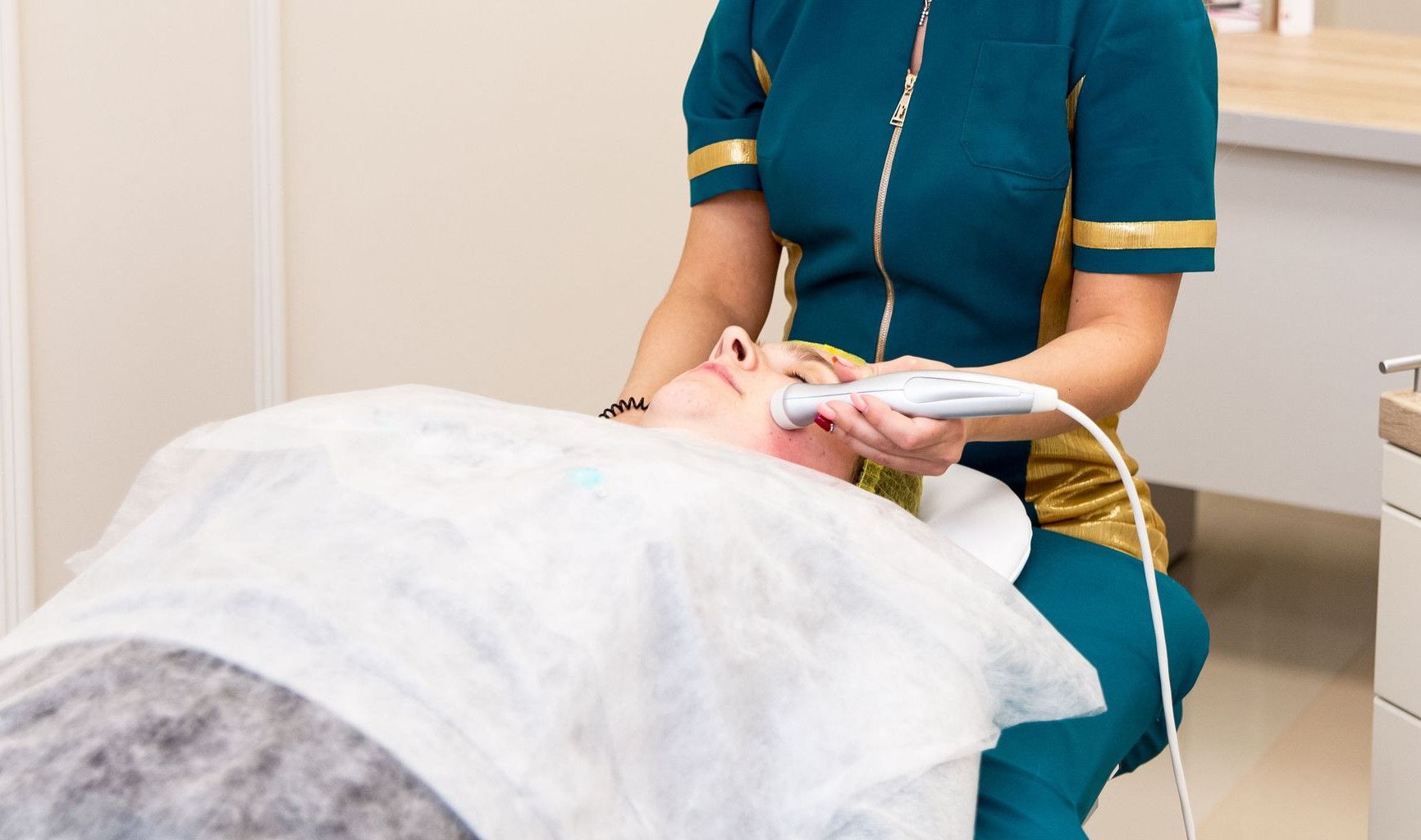 A healthcare professional performing a cosmetic facial treatment on a patient.